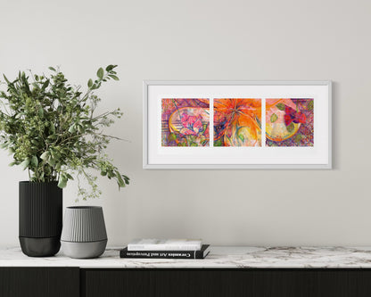 Framed abstract art triptych on a wall above a console table with decorative items.